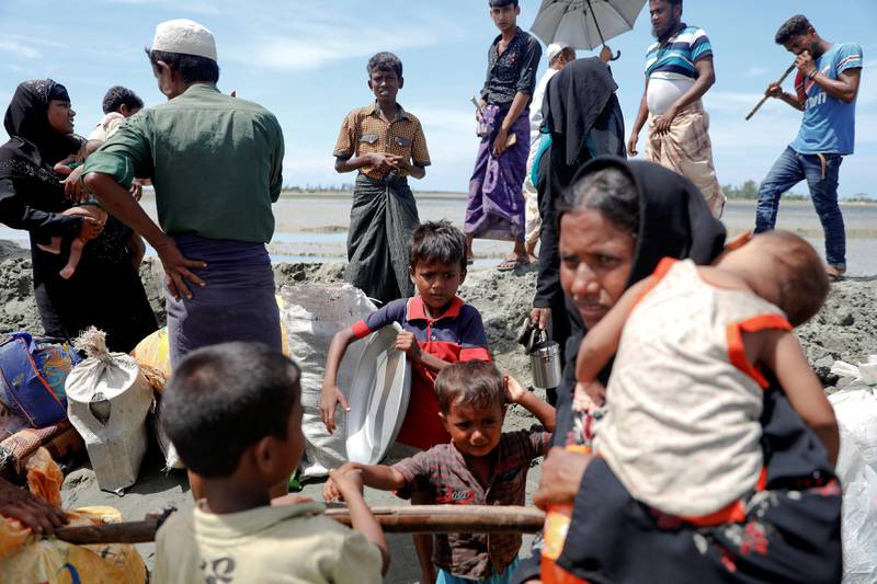 Rohingya refugees who arrived from Myanmar pick up their children and belongings to make their way to a relief centre in Teknaf, near Cox's Bazar in Bangladesh, October 3, 2017.  REUTERS/Damir Sagolj