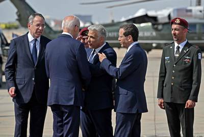 Israel's President Isaac Herzog, second right, and caretaker Prime Minister Yair Lapid, centre, bid farewell to US President Joe Biden at Ben Gurion Airport. AFP