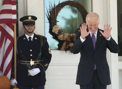 US Vice President Joe Biden reacts as reporters shout questions asking if he has made a decision on whether to run for President as he awaits the arrival of the South Korean President for lunch at the Naval Observatory in Washington, DC, October 15, 2015. AFP PHOTO / SAUL LOEB (Photo by SAUL LOEB / AFP)