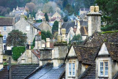 Smoke rises from chimneys in the village of Box, U.K., on Wednesday, Dec. 9, 2020. Jonathan Baylis, founder of LogsNearMe.co.uk, had a hunch that firewood was a Covid-proof business. Photographer: Luke MacGregor/Bloomberg via Getty Images