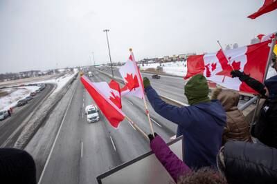 People in Toronto show their support for lorry drivers on their way to Ottawa to protest against cross-border vaccine mandates. Reuters