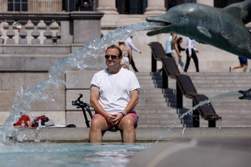A man cools off in a fountain in London. Reuters
