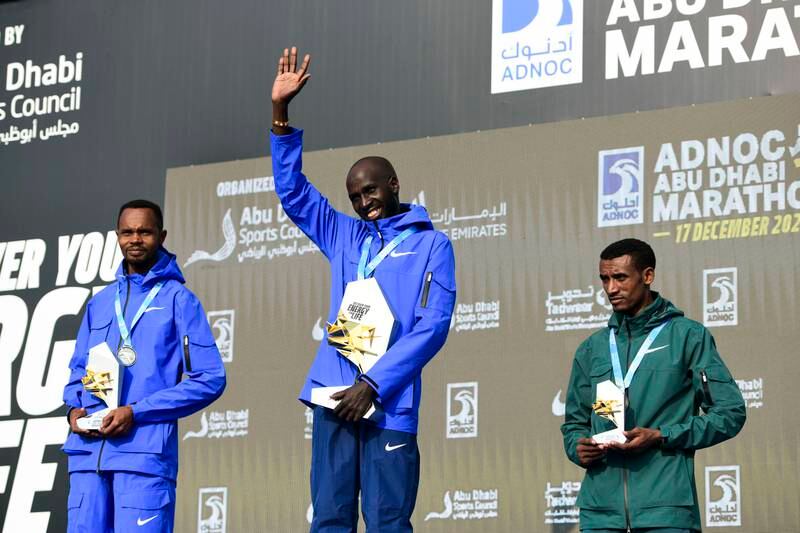 From left, second place runner Felix Kimutai, race winner Timothy Kiplagat, and Adeladhew Mamo at the Abu Dhabi Marathon.