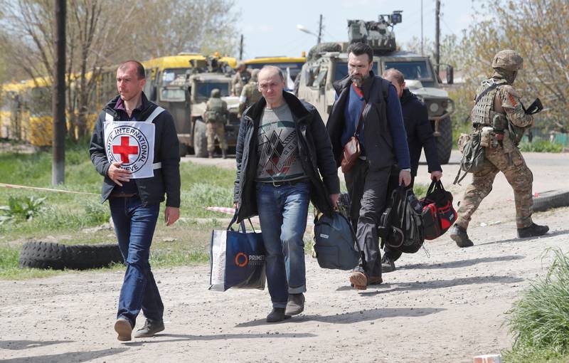Civilians leaving the area near Azovstal steel plant in Mariupol, Ukraine, are accompanied by a member of the International Committee of the Red Cross.  Photo: Reuters
