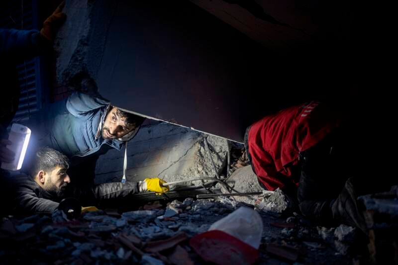 Rescuers search through the rubble for survivors. EPA