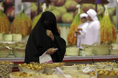 An Emirati visitor looks at dates at the Liwa Dates Festival. Courtesy TCA