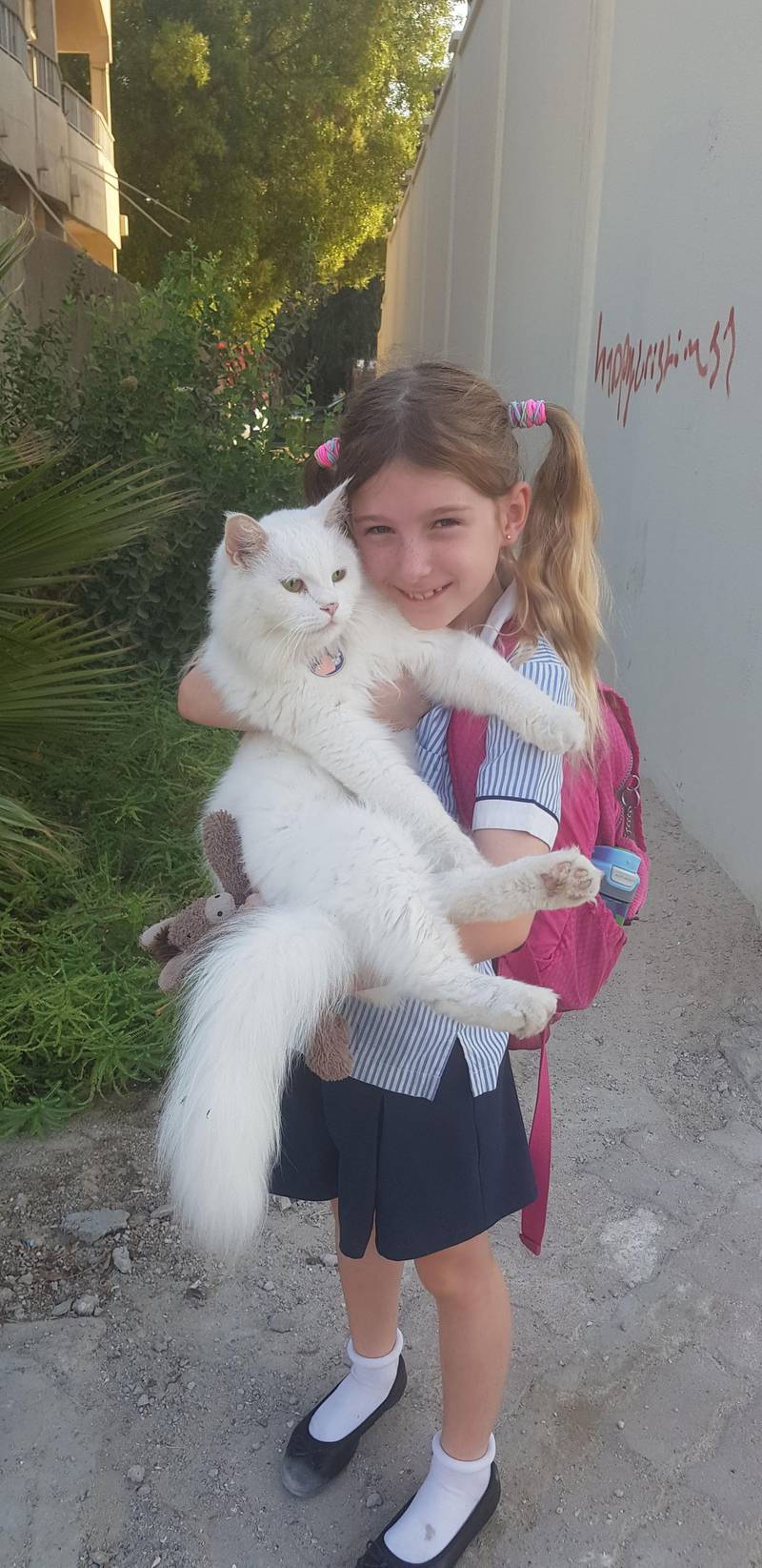 Roberta, a former pupil at Abu Dhabi's British School Al Khubairat, with her cat Whistley