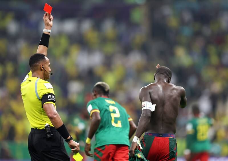 Referee Ismail Elfath shows a red card to Vincent Aboubakar after the Cameroon player took his shirt off after scoring and was booked for a second time. Getty