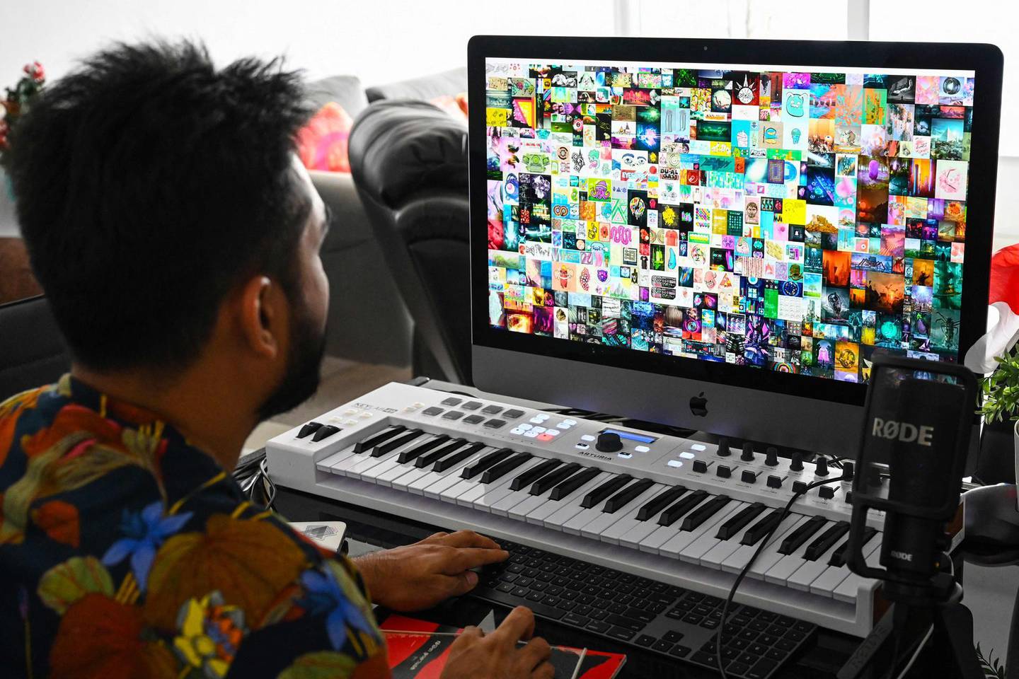 This picture taken on April 7, 2021 shows blockchain entrepreneur Vignesh Sundaresan, also known by his pseudonym MetaKovan, showing the digital artwork non-fungible token (NFT) "Everydays: The First 5,000 Days" by artist Beeple in his home in Singapore. Last month the programmer bought the world's most expensive NFT for $69.3 million, highlighting how virtual work is establishing itself as a new creative genre.  - RESTRICTED TO EDITORIAL USE - MANDATORY MENTION OF THE ARTIST UPON PUBLICATION - TO ILLUSTRATE THE EVENT AS SPECIFIED IN THE CAPTION

TO GO WITH Singapore-US-arts-IT, INTERVIEW by Catherine LAI
 / AFP / Roslan RAHMAN / RESTRICTED TO EDITORIAL USE - MANDATORY MENTION OF THE ARTIST UPON PUBLICATION - TO ILLUSTRATE THE EVENT AS SPECIFIED IN THE CAPTION

TO GO WITH Singapore-US-arts-IT, INTERVIEW by Catherine LAI
