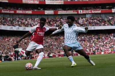 Arsenal's Bukayo Saka, left, and Nottingham Forest's Ola Aina vie for the ball. AP