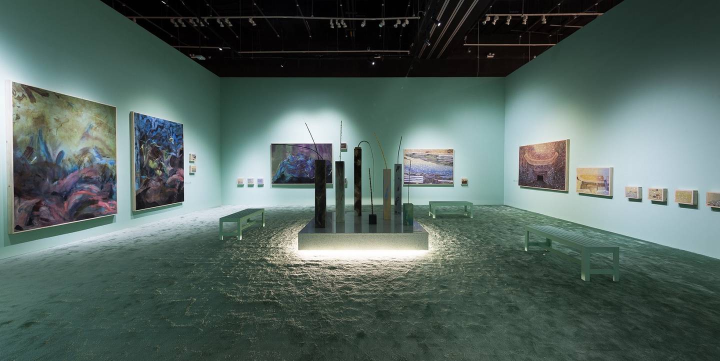 Hashel Al Lamki's blue-green installation 'Neptune', of soft, abstract paintings, refers to the continued plunder of the earth's resources. Photo: Abu Dhabi Art