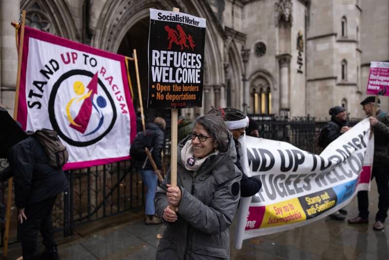 Campaigners staging an anti-Rwanda deportation demonstration outside the Royal Courts of Justice in London. Getty