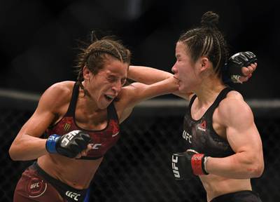 Weili Zhang and Joanna Jedrzejczyk trade blows during their title fight at UFC 248. AFP
