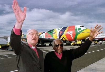 Desmond Tutu greets George Carey, then the Archbishop of Canterbury. Reuters