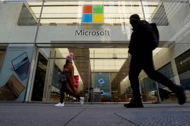 FILE PHOTO: People walk past a Microsoft store in the Manhattan borough of New York City, New York, U.S., January  25, 2021. REUTERS/Carlo Allegri/File Photo  GLOBAL BUSINESS WEEK AHEAD