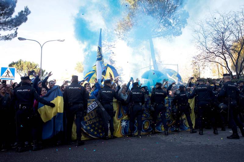 Boca Juniors' fans chant slogans outside the team's hotel in Madrid. EPA