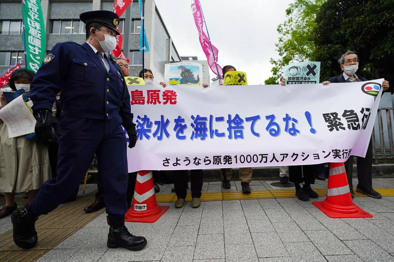 People hold a banner that reads "Don't dump radioactive water into the sea" during a rally outside the prime minister's office in Tokyo. AP