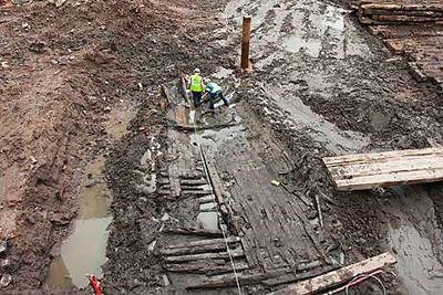 Archeologists take measurements of the wood hull of a ship, believed to be from the 18th century, at the World Trade Center site yesterday.