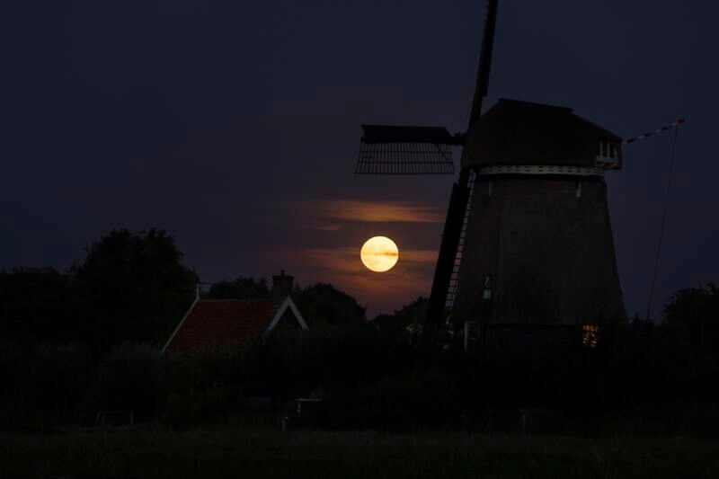 The supermoon rises next to a windmill in Oostzaan, Netherlands. AP