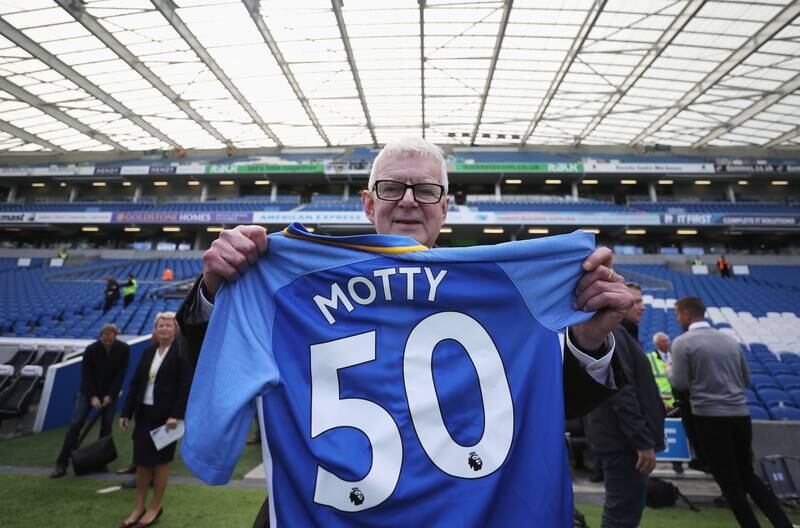 Motson holds a shirt bearing his nickname in Brighton in 2017. Getty Images