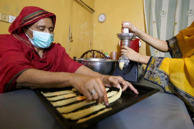 A Sudanese family prepares traditional biscuits at their home in the capital Khartoum ahead of the Eid al-Fitr feast marking the end of the Muslim holy month of Ramadan. AFP