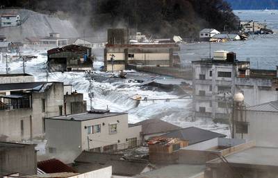 This combination photo taken March 11, 2011, top, and distributed by Kamaishi City, and Wednesday, Feb. 27, 2013 by Kyodo News, shows a view of the harbor area of Kamaishi, Iwate prefecture. Japan next week observes two years from the March 11, 2011 earthquake and tsunami which devastated the northeastern Pacific coast of the country. Japan's progress in rebuilding from the mountain of water that thundered over coastal sea walls, sweeping entire communities away and killing nearly 19,000 people, is mainly measured in barren foundations and empty spaces. Clearing of forests on higher ground to make space for relocation of survivors has barely begun. (AP Photo/Kyodo News) JAPAN OUT, MANDATORY CREDIT, NO LICENSING IN CHINA, FRANCE, HONG KONG, JAPAN AND SOUTH KOREA
