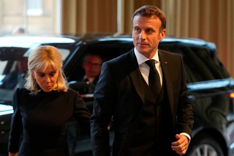 French President Emmanuel Macron and his wife Brigitte arrive for the reception hosted by King Charles. AP