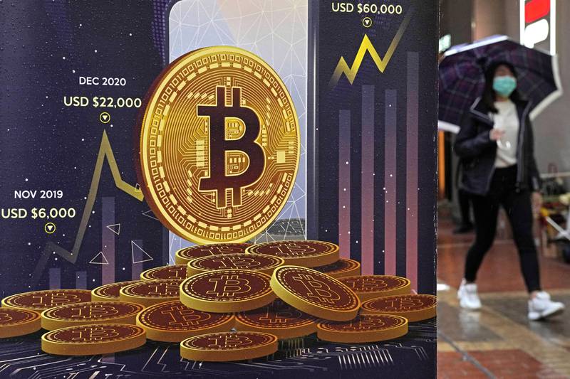 An advertisement for the Bitcoin cryptocurrency is displayed on a street in Hong Kong in February 2022. AP Photo