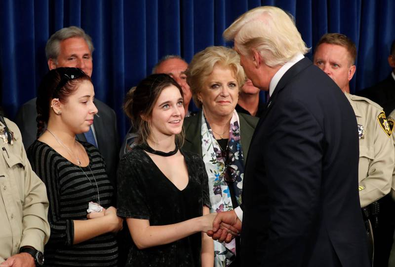 US President Donald Trump is greeted by survivor family members Shelby Stalker and Stephanie Melanson, left, after meeting with Las Vegas Mayor Carolyn Goodman, centre, and police at the Las Vegas Metropolitan Police Department in the wake of the mass shooting in Las Vegas, Nevada, US. Kevin Lamarque / Reuters
