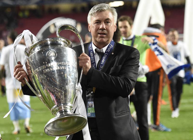 Real Madrid's coach Carlo Ancelotti with the Champions League title on May 24, 2014. Real Madrid defeated Atletico Madrid 4-1 at the Luz Stadium in Lisbon. AFP