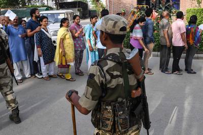 A security personnel stands guard at a polling station during India's general election in Ghaziabad, Uttar Pradesh. AFP