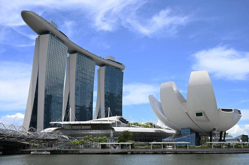 A general view of Marina Bay Sands hotel and resort (L) and the ArtScience Museum (R) are seen in Singapore on March 26, 2021. (Photo by Roslan RAHMAN / AFP)