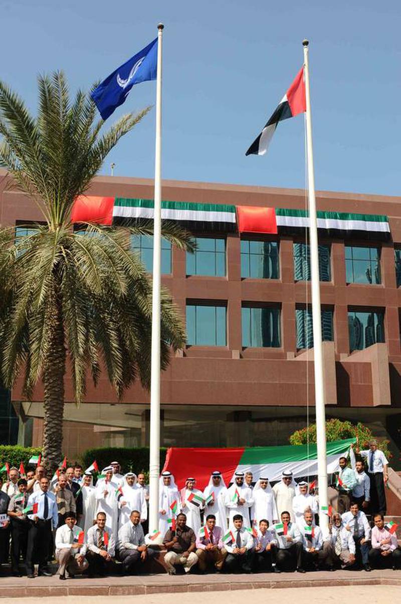 Hussain Kazim raising the UAE’s Flag over Emarat Head Office. Courtesy Emarat


