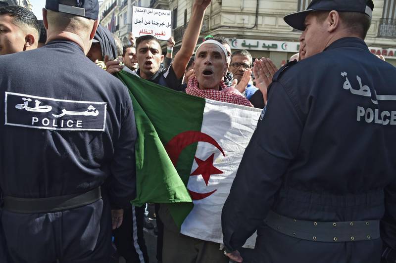 Members of the Algerian police block the progress of an anti-government demonstration in the center of the capital Algiers. AFP