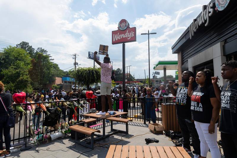 Demonstrators protest outside a Wendy's restaurant which was destroyed in Atlanta, Georgia.  EPA