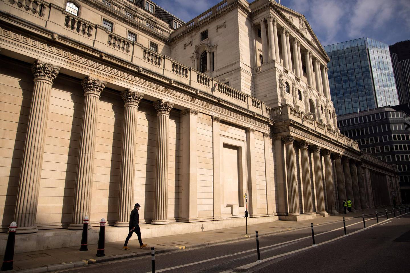 A pedestrian passes the Bank of England in London, U.K., on Monday, March 22, 2021. U.K. Prime Minister Boris Johnson told the country that people 'must' stay at home and certain businesses must close on March 23, 2020. Photographer: Jason Alden/Bloomberg