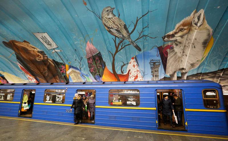 A train passes by a mural depicting a bear on the walls of a metro station in Kiev. AP Photo