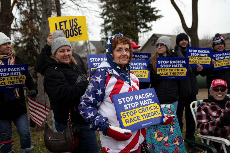Supporters hold posters regarding critical race theory in Ortonville, Michigan, last November. Reuters