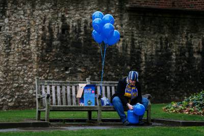 Anti-Brexit campaigner inflates a balloon opposite the Houses of Parliament in London. Getty Images