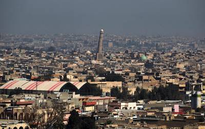 A general view shows the leaning minaret of the Great Mosque of al-Nuri in Mosul, on March 10, 2017, as Iraqi forces shell enemy positions during an offensive to retake the western parts of the city from the jihadists. (Photo by AHMAD AL-RUBAYE / AFP)
