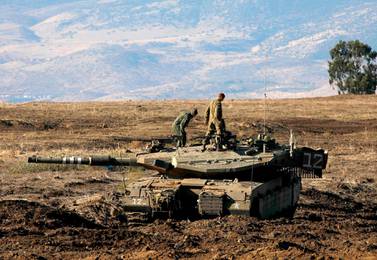 Israeli soldiers and armoured vehicles are pictured on November 19, 2019 near the border with Syria in the annexed Golan Heights. AFP