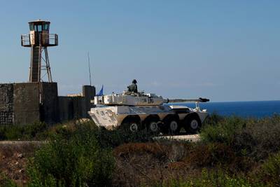 A UN peacekeeper sits atop a light tank near the post where the indirect talks between Israel and Lebanon were being held in the southern Lebanese border town of Naqoura, Lebanon, Wednesday, Oct. 14, 2020. Lebanon and Israel are to begin indirect talks Wednesday over their disputed maritime border, with American officials mediating the talks that both sides insist are purely technical and not a sign of any normalization of ties. (AP Photo/Bilal Hussein)