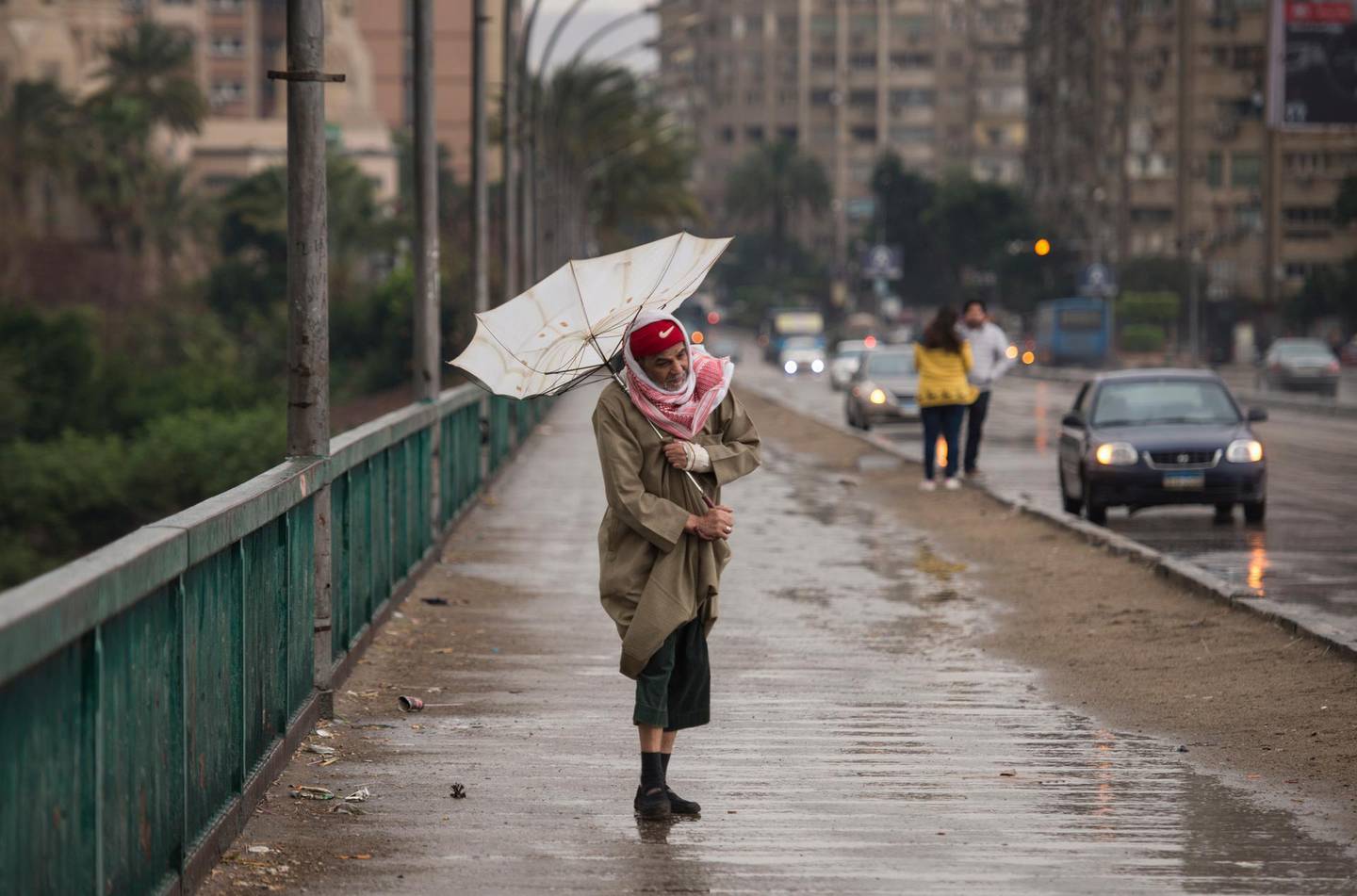 epa08288251 A man walks during a thunderstorm and heavy rains in Cairo, Egypt, 12 March 2020. The government announced the closure of schools and universities nationwide, planned sports events and matches are postponed. It is urging people to stay home, as the rain may exceeds the infrastructure's capacity in most cities.  EPA/Mohamed Hossam