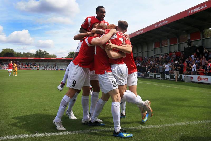 SALFORD, ENGLAND - AUGUST 04: Salford players including Ibou Touray (top) celebrate their opening goal during the Vanarama National League match between Salford City and Leyton Orient at Moor Lane on August 4, 2018 in Salford, England. (Photo by Simon Stacpoole/Offside/Getty Images)