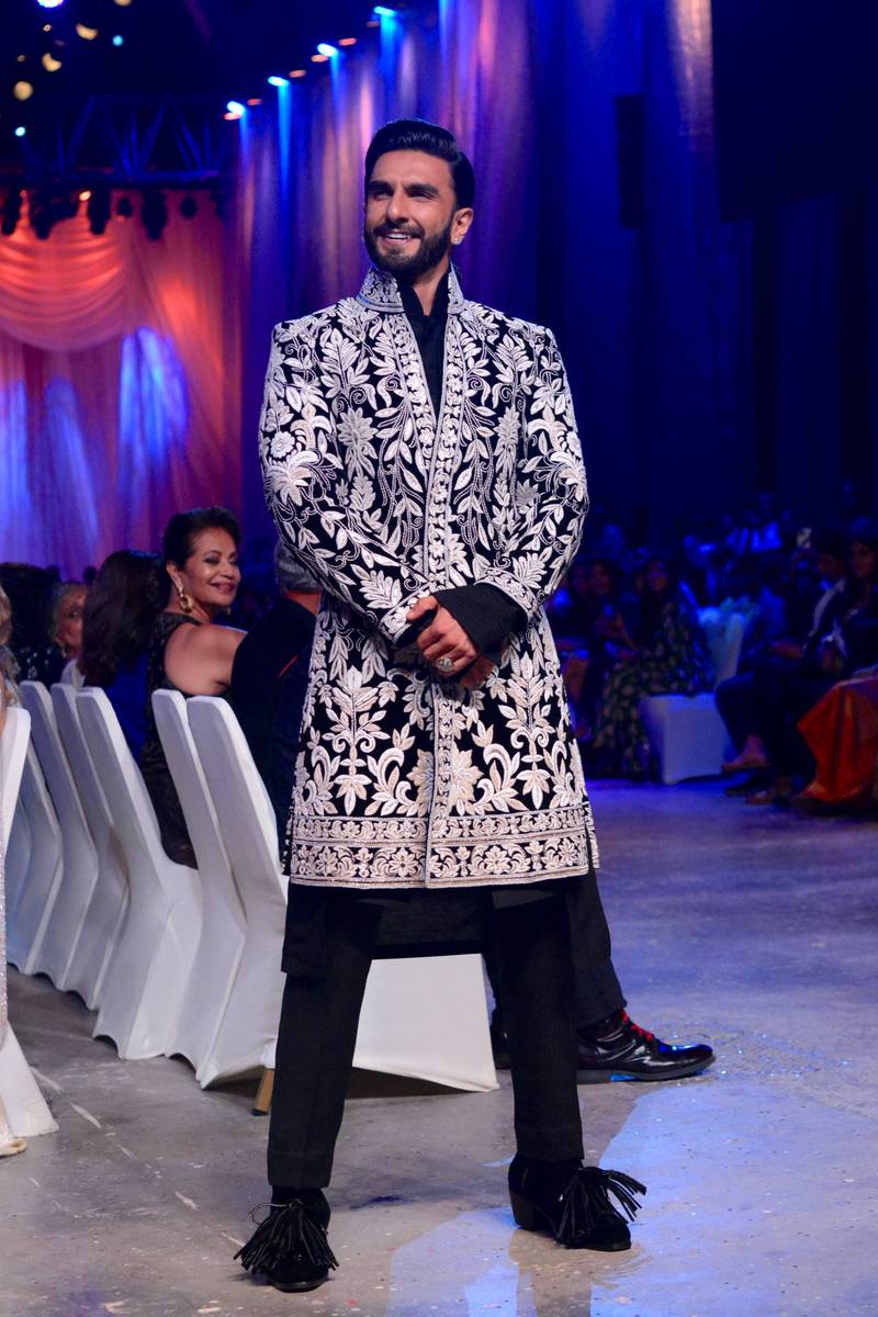 Singh wore a black sherwani with white embroidery and black trousers that complemented Padukone's look.