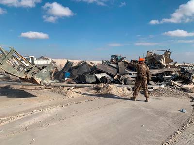 US soldiers clear rubble from a site of Iranian bombing at Ain Al Asad air base in Anbar. AP
