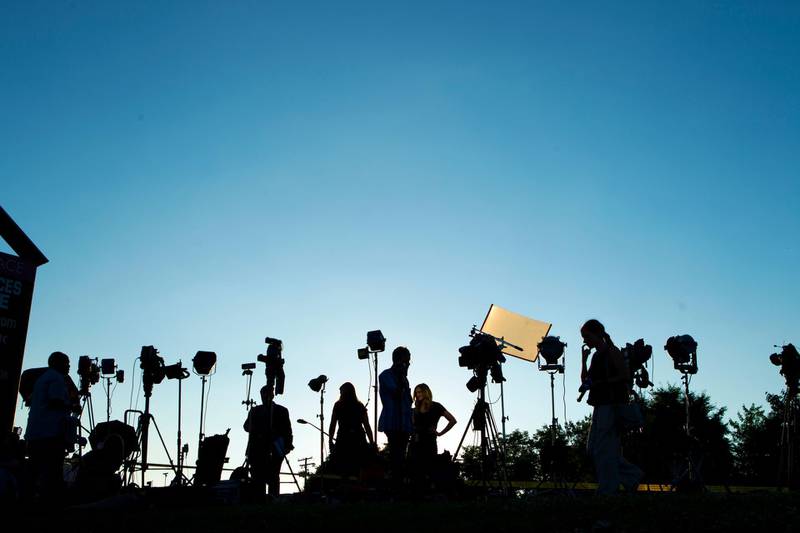 TV crews waiting for a news conference line up at the side of the road across the newspaper office building where multiple people were shot this afternoon inside of the newsroom, in Annapolis, Md., Thursday, June 28, 2018. (AP Photo/Jose Luis Magana)