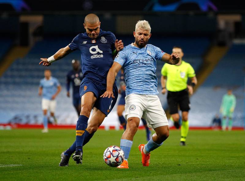 MANCHESTER, ENGLAND - OCTOBER 21: Sergio Aguero of Manchester City with Pepe of Porto during the UEFA Champions League Group C stage match between Manchester City and FC Porto at Etihad Stadium on October 21, 2020 in Manchester, England. Sporting stadiums around the UK remain under strict restrictions due to the Coronavirus Pandemic as Government social distancing laws prohibit fans inside venues resulting in games being played behind closed doors. (Photo by Phil Noble - Pool/Getty Images)