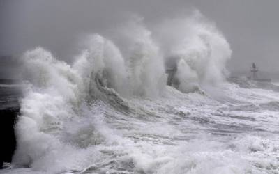 Waves hit a jetty in western France as Storm Ciara sweeps across western Europe.  AFP