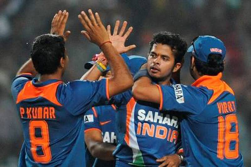 Indian cricketer Shanthakumaran Sreesanth celebrates with teammates after taking the wicket of unseen South African cricketer Roelof van der Merwe during the second One Day International (ODI) cricket match at the Captain Roop Singh Stadium in Gwalior on February 24, 2010. South Africa is currently 103 runs for the loss of six wickets chasing India's score of 401 runs.  FP PHOTO/ MANAN VATSYAYANA *** Local Caption ***  942708-01-08.jpg
